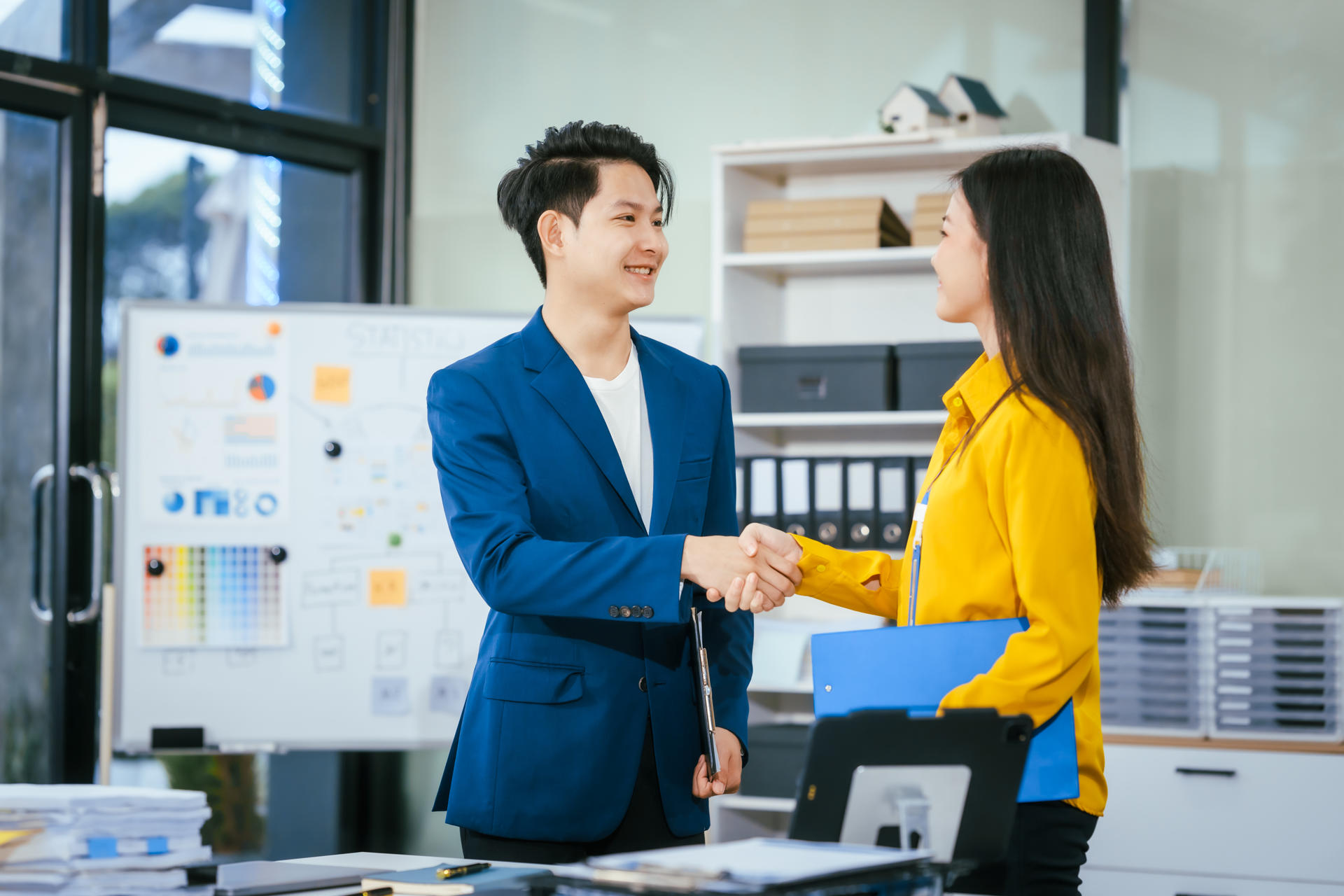 a-businessman-and-businesswoman-shake-hands